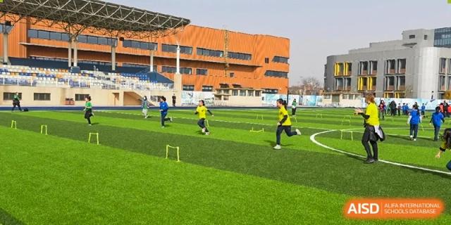 Students at Yew Wah International Education School Of Beijing Yizhuang Campus play an outdoor sport.
