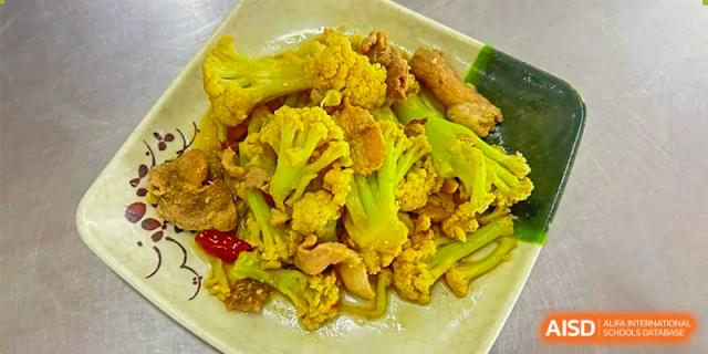 A close-up dish of savory stir-fried cauliflower and other vegetables served as a meal at ZHANGQIU BILINGUAL INTERNATIONAL SCHOOL.