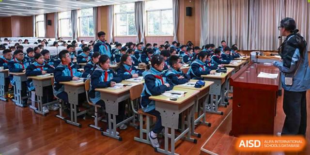 Students from Nanjing Dongshan Foreign Language School International Department are seated at their desks, listening to a lesson.