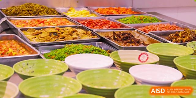 Trays of different dishes are available in a cafeteria at Nanjing Dongshan Foreign Language School International Department.