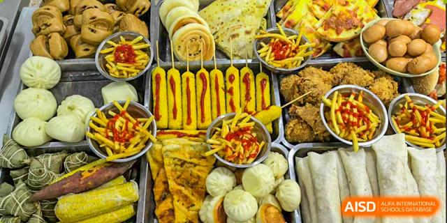 A close-up of different fried snacks and steamed buns served in the cafeteria at Nanjing Dongshan Foreign Language School International Department.