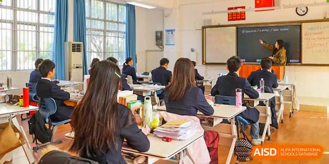 Students from Nanning No.2 High School International Division are working at their desks in a classroom.