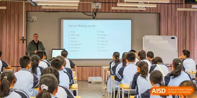 A teacher is using a projector screen to show a lesson to students from Nanning No.2 High School International Division.