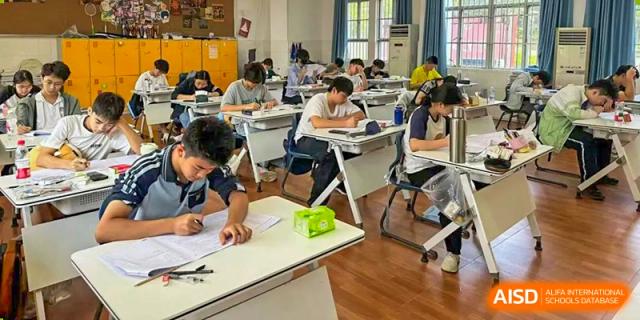 Students from Nanning No.2 High School International Division are seated at their desks, studying and listening to a lesson.