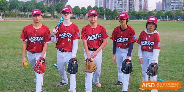 Students from Nanning No.2 High School International Division are wearing baseball uniforms and standing on a field.