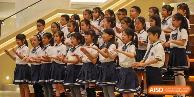 Students from BASIS International & Bilingual Schools Chengdu in a music or dance class, following their instructor's lead.