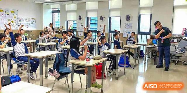 Students at BASIS International & Bilingual Schools Chengdu working at their desks in a busy classroom.