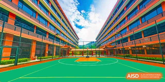 An outdoor basketball court on the campus of BASIS International & Bilingual Schools Chengdu, with modern school buildings in the background.