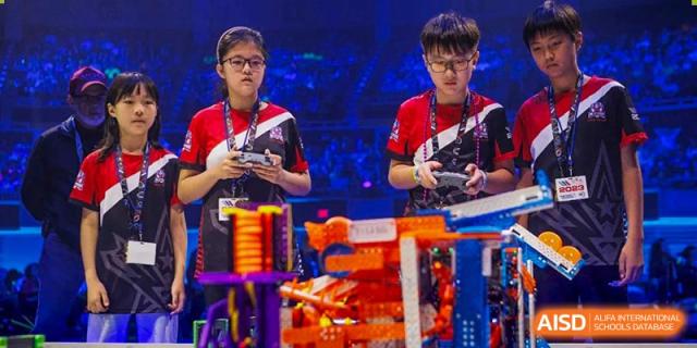 Students from BASIS International & Bilingual Schools Chengdu with colorful robots, possibly in a robotics class.