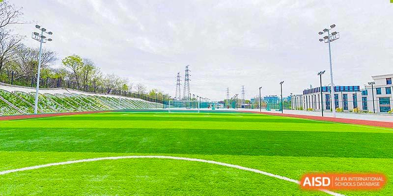 A wide, open green sports field at BASIS International & Bilingual Schools Chengdu.