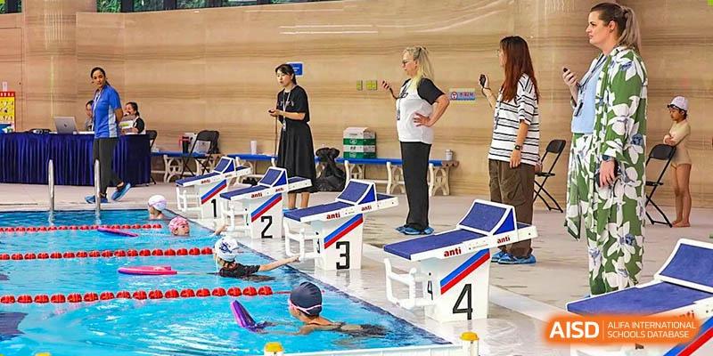 A swimming instructor coaching students at the indoor pool of BASIS International & Bilingual Schools Chengdu.