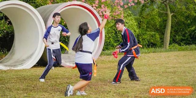 BASIS International & Bilingual Schools Chengdu students playing an outdoor game with a large ring.