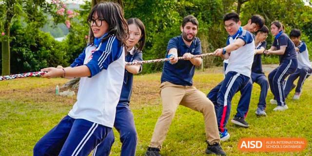 A teacher and students from BASIS International & Bilingual Schools Chengdu playing tug-of-war.