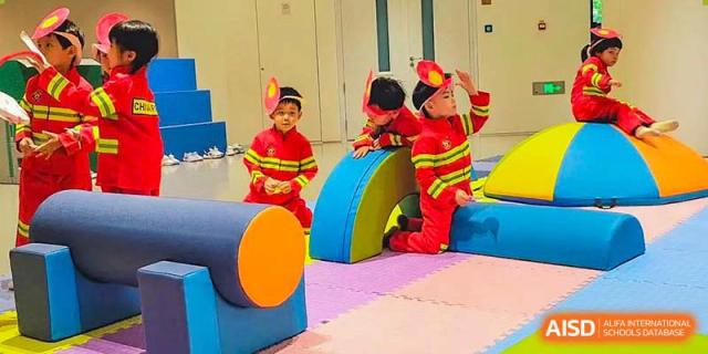 Young students from BASIS International & Bilingual Schools Chengdu playing on colorful soft blocks in a classroom.