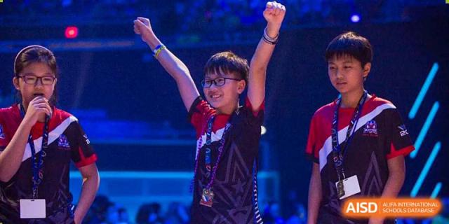 A student from BASIS International & Bilingual Schools Chengdu raising their hands in victory during a competition.
