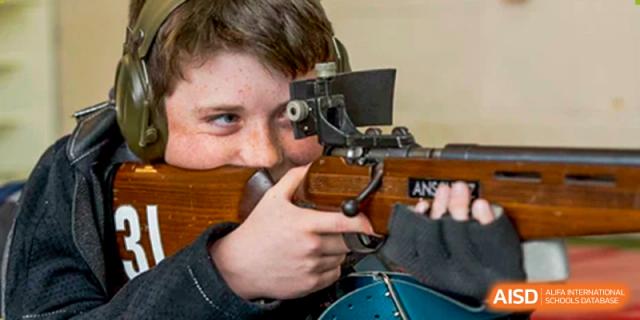A Merchiston International School Shenzhen student focusing through a rifle sight during a supervised target practice or shooting sport activity.