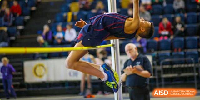 A Merchiston International School Shenzhen student performing a high jump over the bar during a track and field competition.