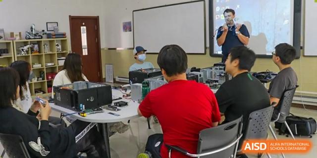 A student and teacher are working on a computer project together in a classroom at Shenyang International School.