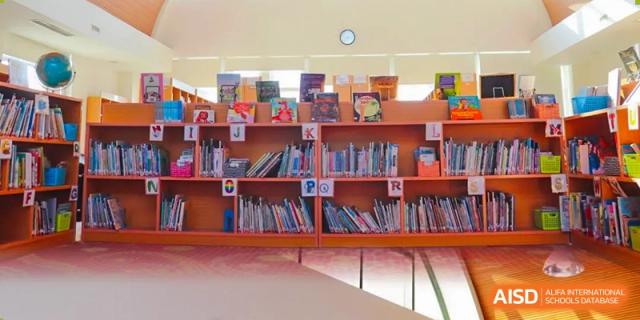Bookshelves are filled with books in a library at Shenyang International School.