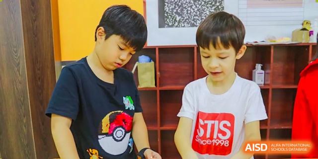 Two young students are working on a project in a classroom at Shenyang International School.