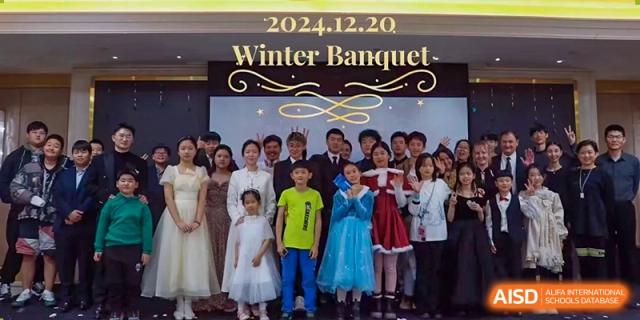 A large group of students is dressed up for the 2024 Winter Banquet at Shenyang International School.