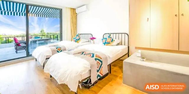 Two beds are in a bedroom in the dormitory at Shenyang International School.