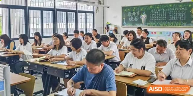 Shenzhen Yaohua Experimental School students studying and working at their desks in a brightly lit classroom with large windows.