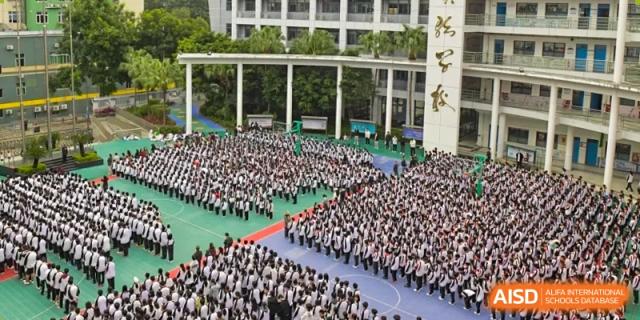 An aerial view of the large student body of Shenzhen Yaohua Experimental School gathered in formation on the campus grounds.