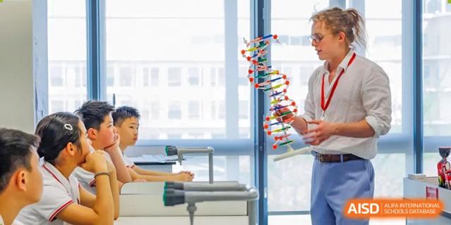 A student constructing a DNA model in a science class, SPGS International School Chengdu