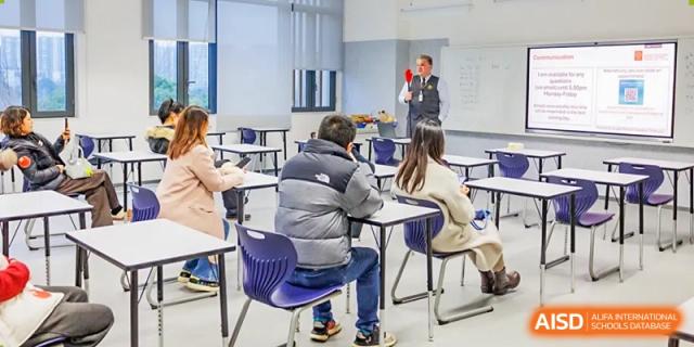Students sitting at desks while a teacher gives a presentation, SPGS International School Chengdu