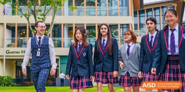 Two female students in school uniform smiling outside, SPGS International School Chengdu