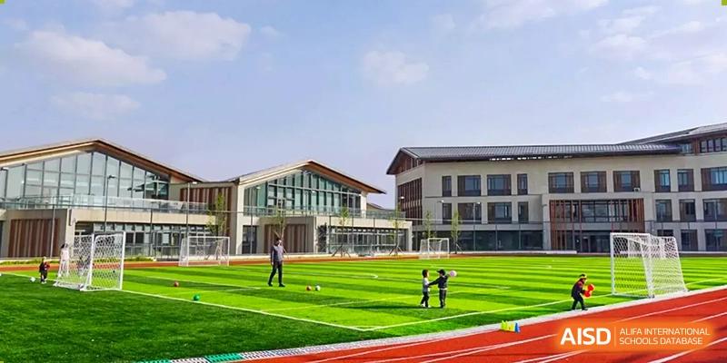 Students playing on a sports field with a running track, SPGS International School Chengdu
