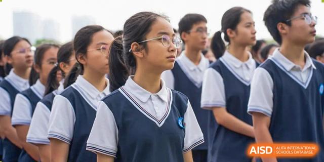 A student looking up, wearing a school uniform at Huzhou South Taihu Bilingual School.