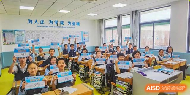 A busy classroom with students sitting at desks and a teacher at the front at Huzhou South Taihu Bilingual School.