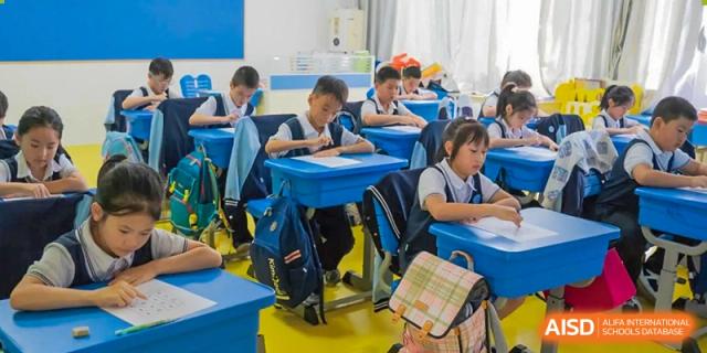 Students studying and looking at their phones in a classroom at Huzhou South Taihu Bilingual School.