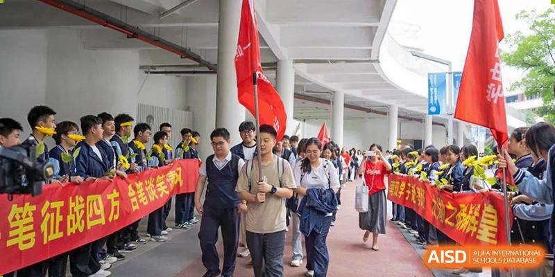 Students and a teacher walking in a line, possibly during a school event, at Huzhou South Taihu Bilingual School.