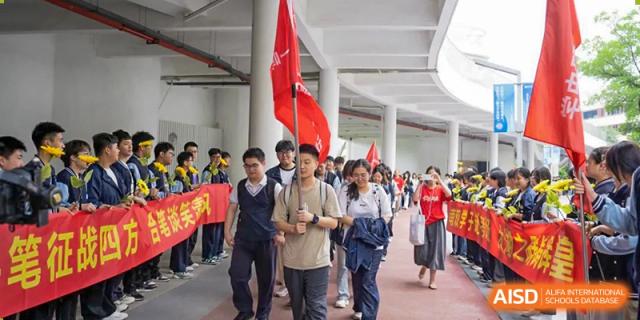 Students and a teacher walking in a line, possibly during a school event, at Huzhou South Taihu Bilingual School.