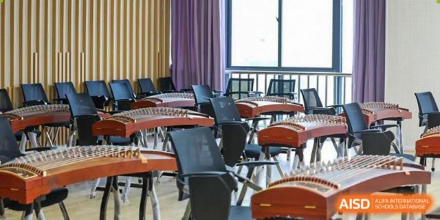 An empty music or art room with chairs and music stands at Huzhou South Taihu Bilingual School.
