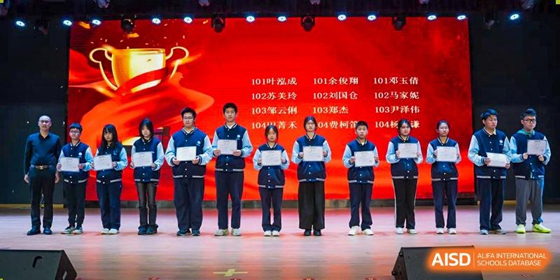 Students standing on a stage during an event at Huzhou South Taihu Bilingual School.