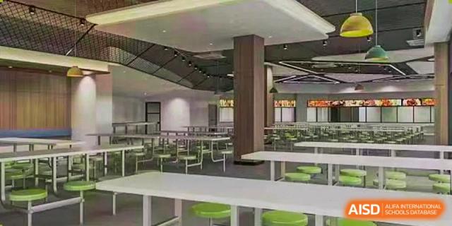 An empty dining hall with modern tables and chairs at Huzhou South Taihu Bilingual School.