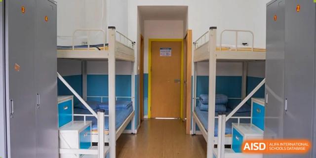 An empty school dormitory room with bunk beds at Huzhou South Taihu Bilingual School.
