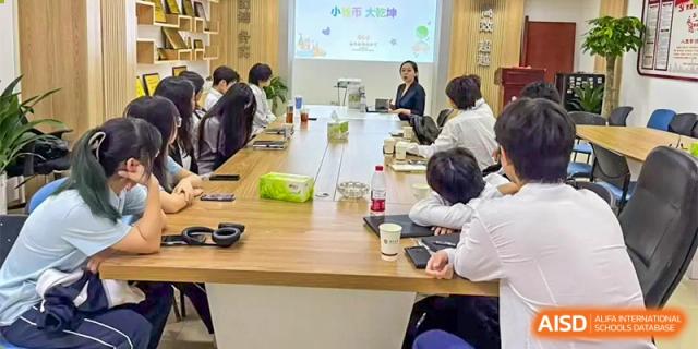 A group of students and a teacher from The First High School of Changsha, Hunan participating in a business or project meeting around a large conference table.