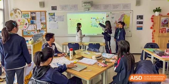A BASIS International School Nanjing student giving a presentation in a classroom.