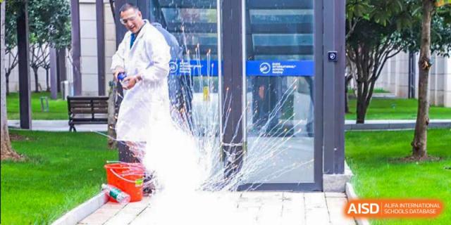 A BASIS International School Nanjing student in a lab coat performing a science experiment with a liquid.