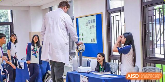 A BASIS International School Nanjing student and teacher looking at a science fair project.
