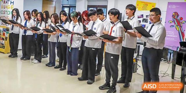 A group of BASIS International School Nanjing students in uniform are standing in a line.