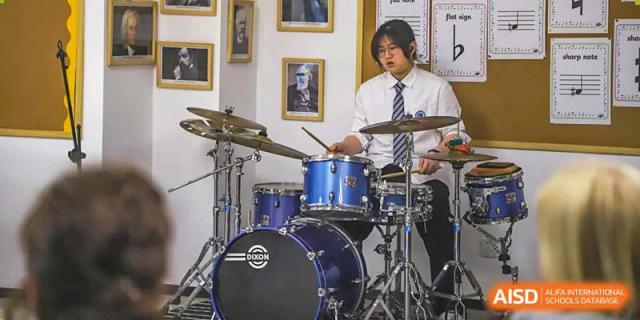 A BASIS International School Nanjing student playing the drums.