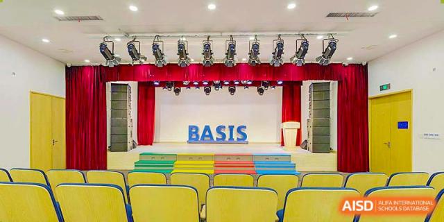 An empty stage and auditorium at BASIS International School Nanjing.