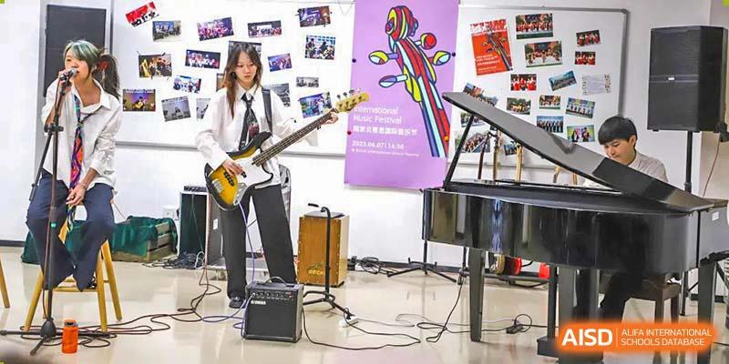 A stage with a microphone stand and musical instruments at BASIS International School Nanjing.
