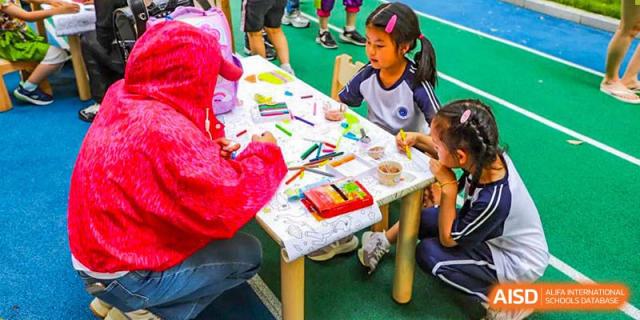 A young BASIS International School Nanjing student drawing at a table.